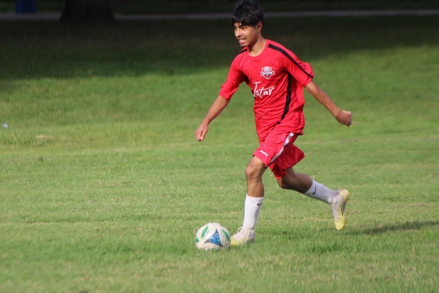 A Dixon FC player runs with the ball
