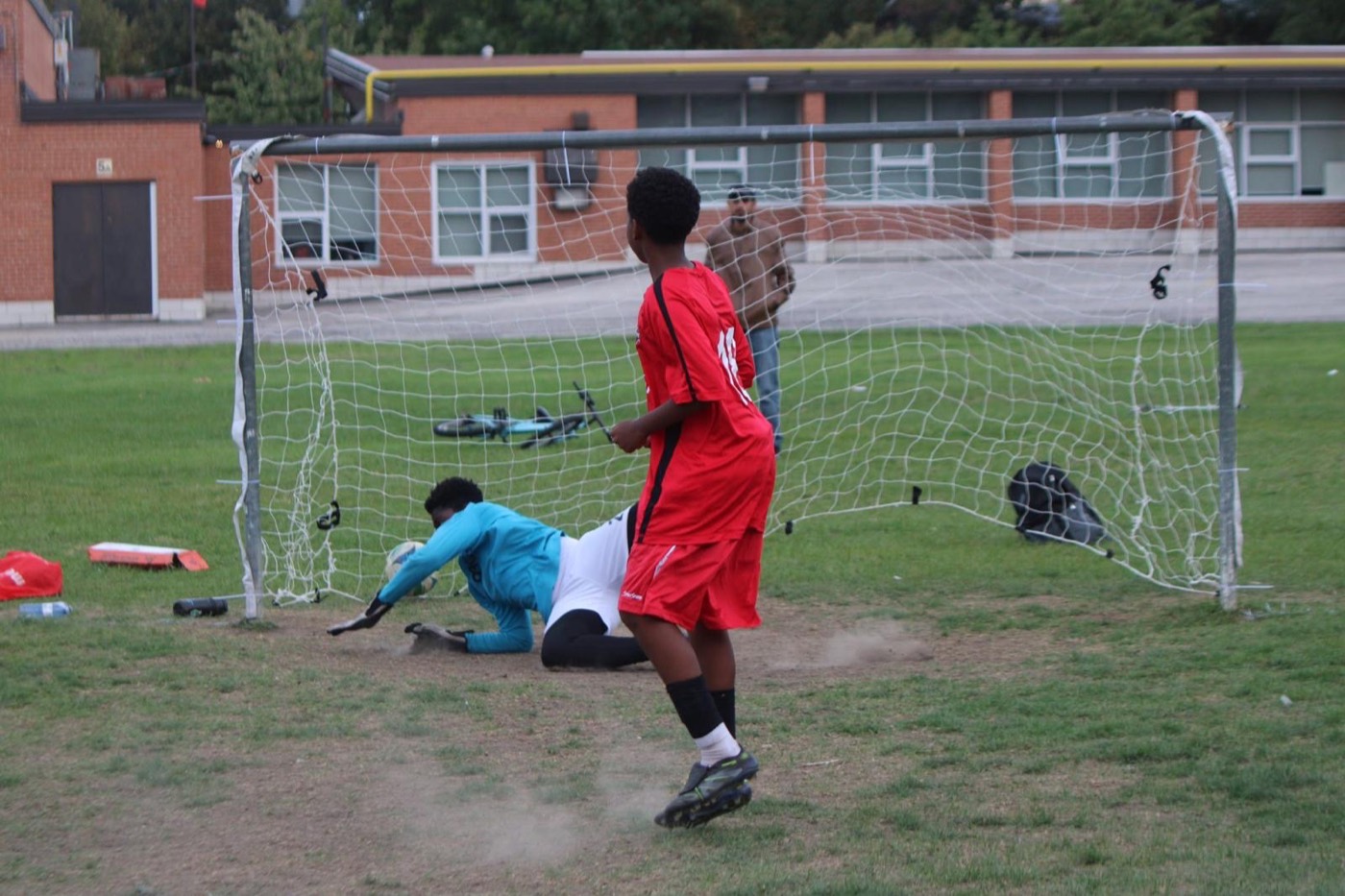 A young player walks back after scoring