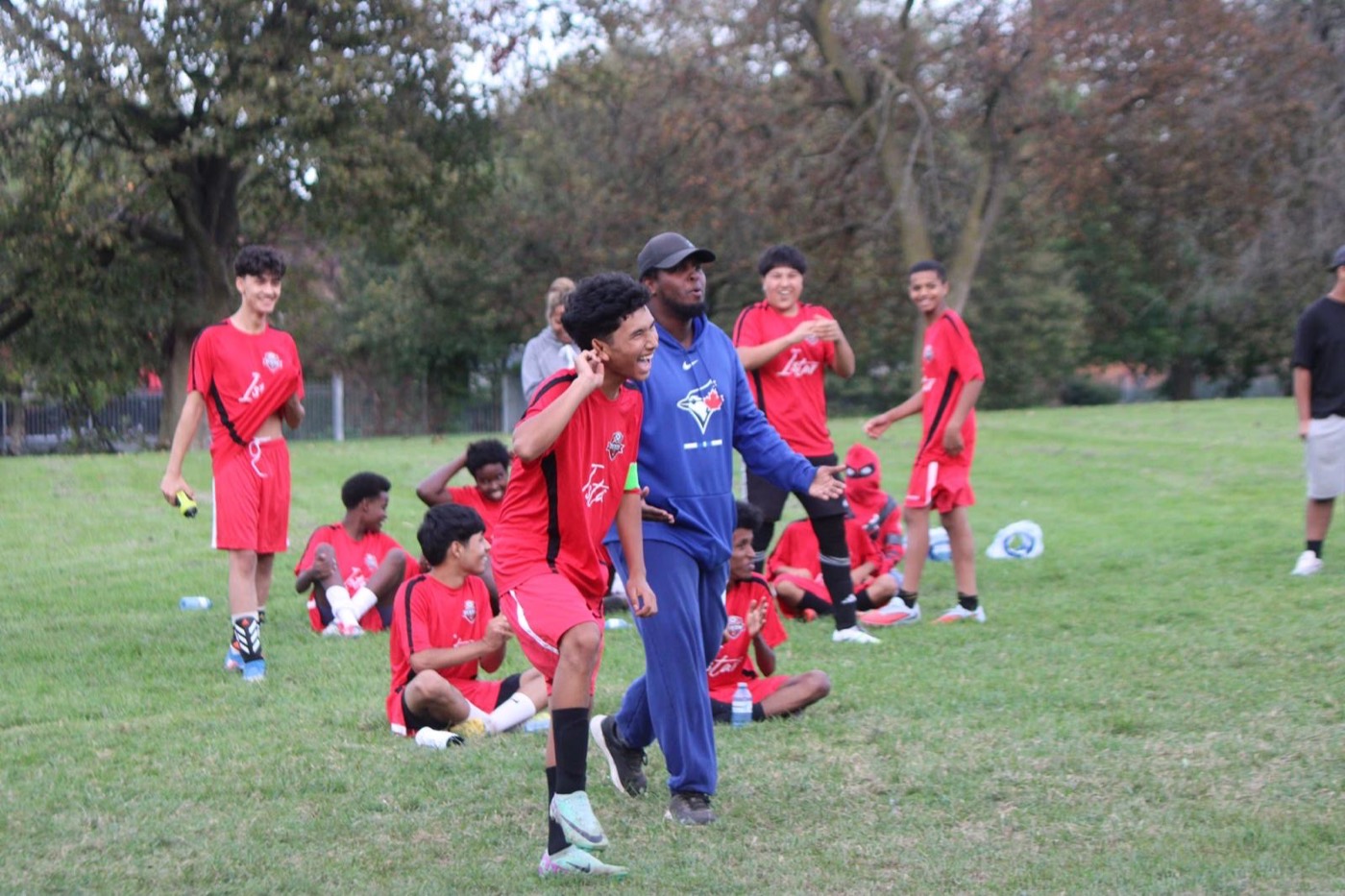 A DYES coach celebrates with young players
