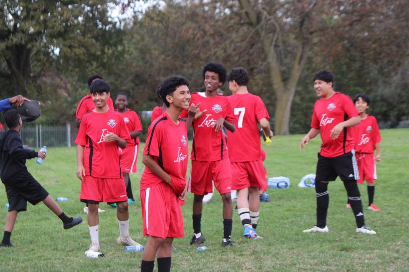 Young people in Dixon FC kits celebrate together